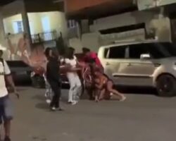 During a girl fight, one of them is hit by a motorcycle