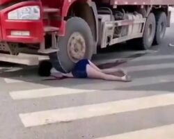 Woman stuck under a truck in China
