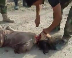 Soldiers cut off head of a dead ISIS fighter