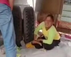 Mother tries to save child trapped under tyre
