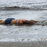 Dead young woman found on beach