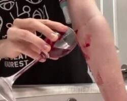 Girl cut her arm and filled wine glass with her blood