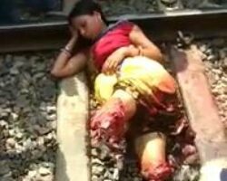 Girl with both legs cut off relaxes on railway