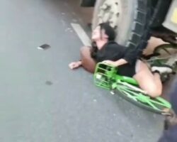 Woman in extreme pain wedged under truck wheel