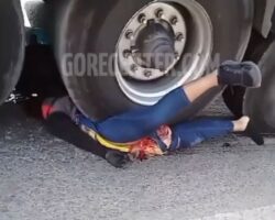 Crushed woman under wheels of tanker truck