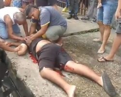 Guy standing at roadside is assassinated by two hitmen