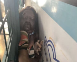 Woman crushed against fence by bus