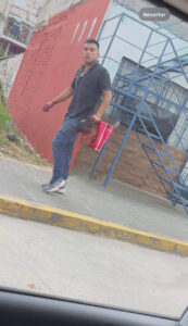 Guy walks down the street holding severed human head in his hand