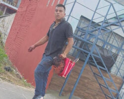 Guy walks down the street holding severed human head in his hand
