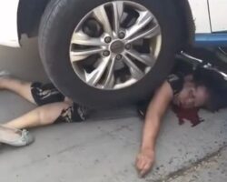Chinese woman fatally trapped under car