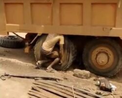 Mechanic crushed between wheel and trailer