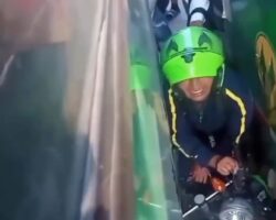 Motorcyclist trapped between two buses