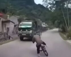 Elderly man falls head first from his bicycle under truck