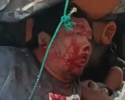 One dead, another trapped after collision between two trucks