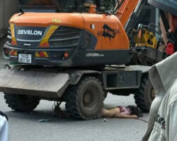 Pedestrian run over by excavator in the middle of intersection