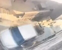 Woman on stairs hit by reversing pickup truck