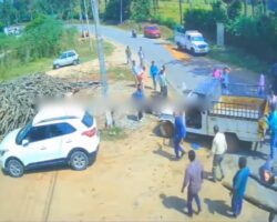 Pickup truck flipped over its roof with people in cargo bed