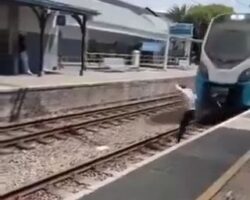 Frustrated man jumps in front of moving train