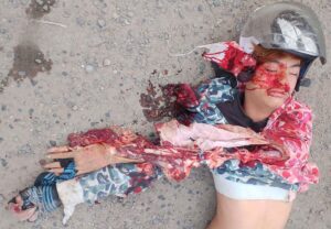 Cambodian woman thrown from moped under truck