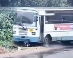 Motorcyclist slips and ends up under bus