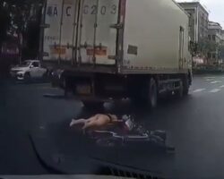 Woman riding moped turns straight into path of moving truck