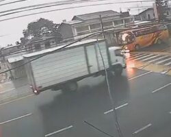 Motorcyclist turns directly under truck