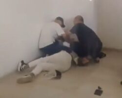 Two Chinese businessmen strangling their African female employee