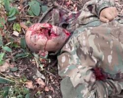 Ukrainian soldier shows fallen Russian soldier