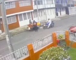 Female motorcyclist crashes into street vendor