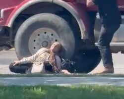 Elderly woman struck and dragged by dump truck