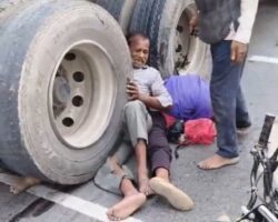 Three men hit by truck, one trapped under wheel