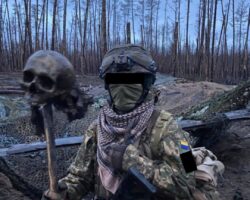 Ukrainian soldiers pose with Russian soldier’s skull
