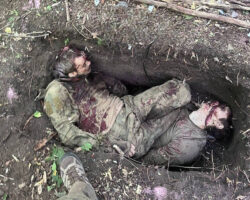 Burying two fallen Russian soldiers in shallow grave