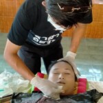 Preparing dead body of woman for burial