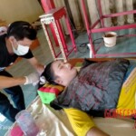 Preparing dead body of woman for burial