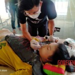 Preparing dead body of woman for burial