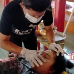 Preparing dead body of woman for burial