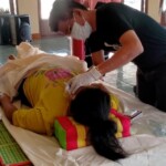 Preparing dead body of woman for burial