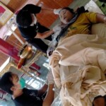 Preparing dead body of woman for burial