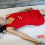 Strangled young woman in red dress