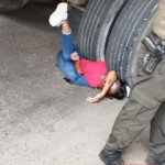 girl wedged under tractor wheel