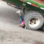 girl wedged under tractor wheel