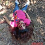 Executed young woman on dirt road