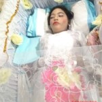 Asian woman in open coffin