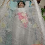 Asian woman in open coffin