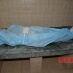 Initial examination of dead woman by forensic pathologists