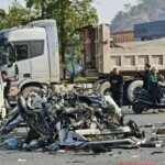 Car loses control and hits truck, one dead