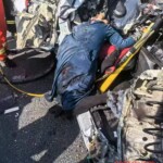 Car loses control and hits truck, one dead