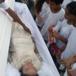 Funeral of Indonesian woman with open casket