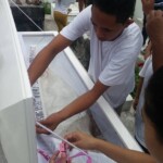 Funeral of Indonesian woman with open casket